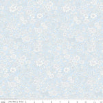Pale blue cotton fabric with allover white floral print by Riley Blake Designs