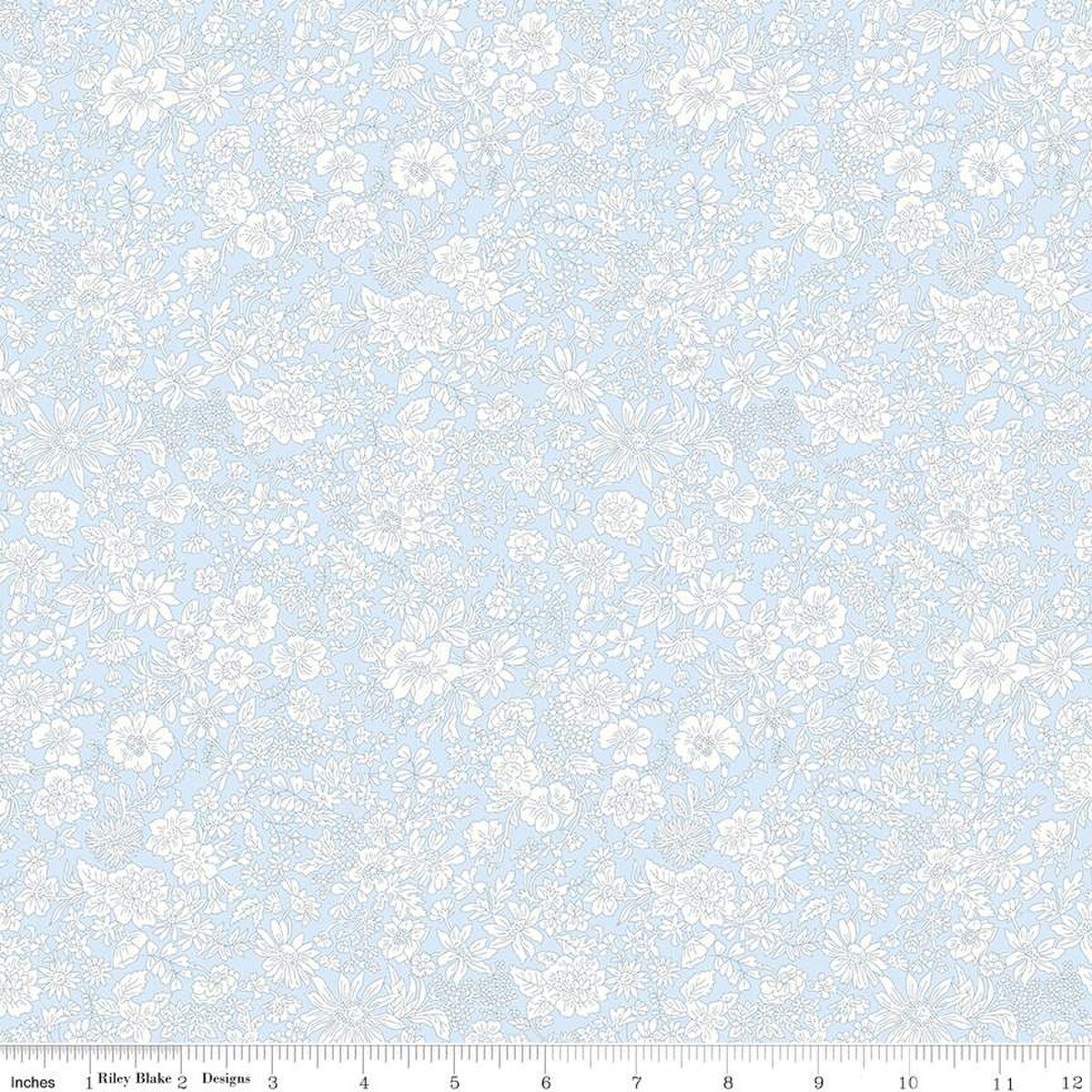 Pale blue cotton fabric with allover white floral print by Riley Blake Designs