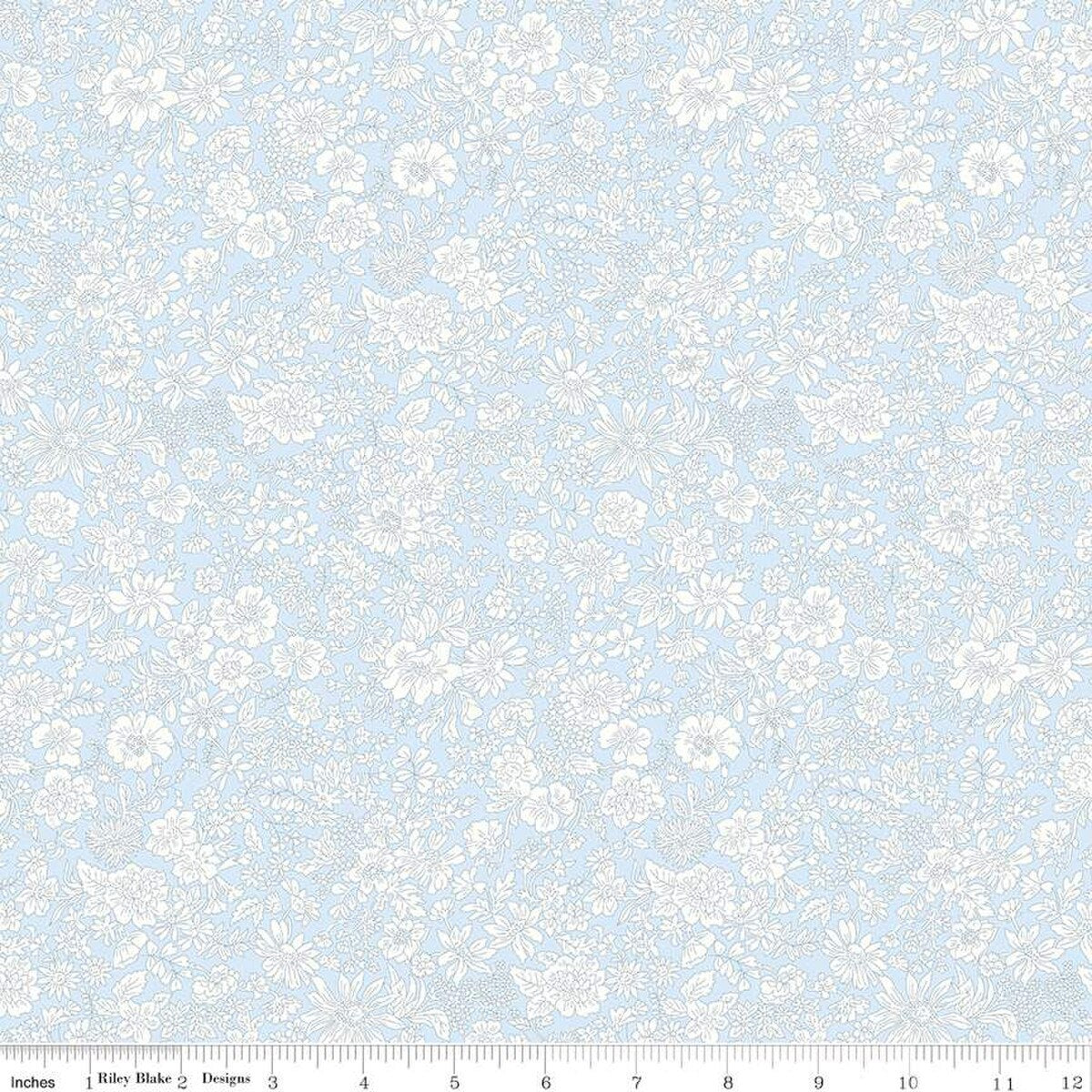 Pale blue cotton fabric with allover white floral print by Riley Blake Designs