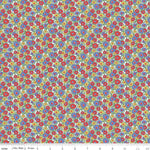 White cotton fabric with dense red, blue, and yellow daisy floral print pattern