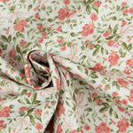 White cotton poplin fabric with pink roses, green leaves, and bow print pattern.