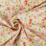 Cream corduroy fabric with scattered pink floral print twisted into a swirl