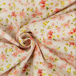 Light pink corduroy fabric with scattered pink floral and yellow-green leaf print, swirled display