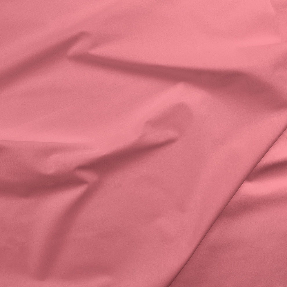 Solid petunia pink cotton fabric with soft drape and subtle folds