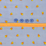 Blue candy corn print fabric with four blue buttons and orange gingham ribbon trim
