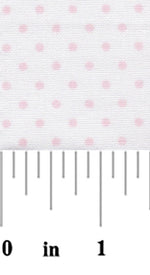 White fabric with small evenly spaced baby pink polka dots, shown with ruler