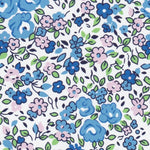 White cotton fabric with blue and pink floral print and green leaves