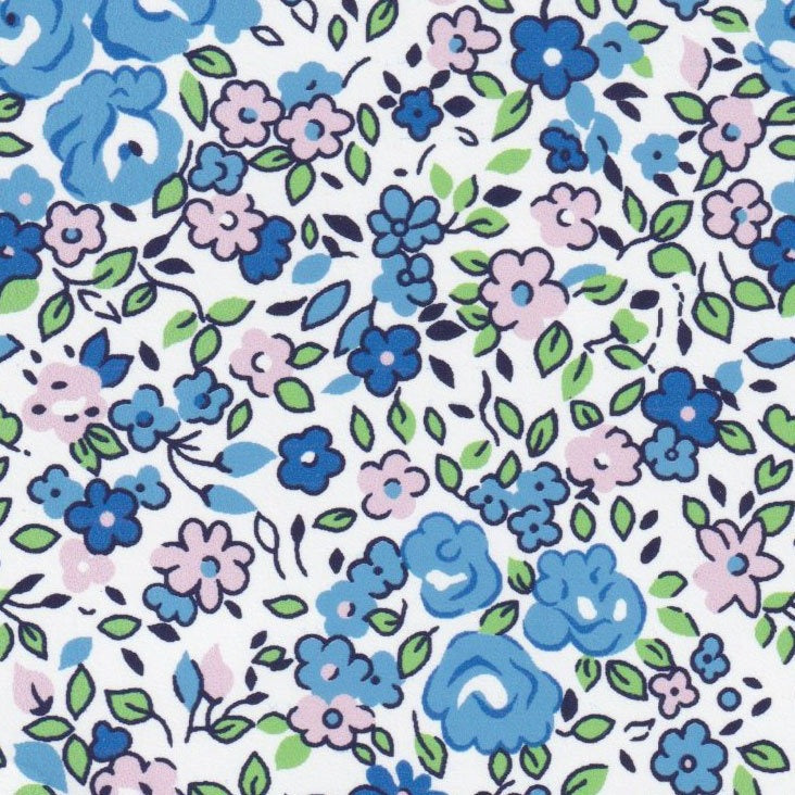 White cotton fabric with blue and pink floral print and green leaves