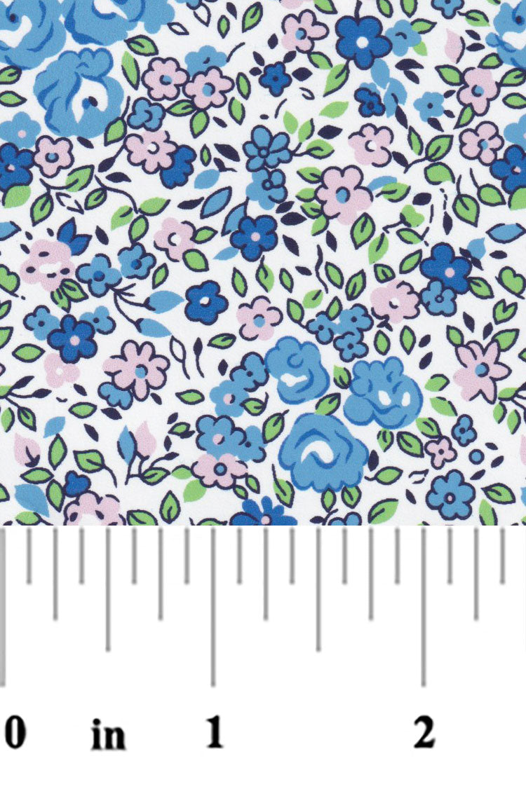 White cotton fabric with blue and pink floral print, small roses and leaves pattern