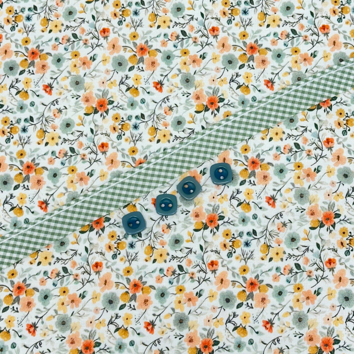 Floral cotton fabric with green gingham trim and four teal buttons for Georgia Dress Kit