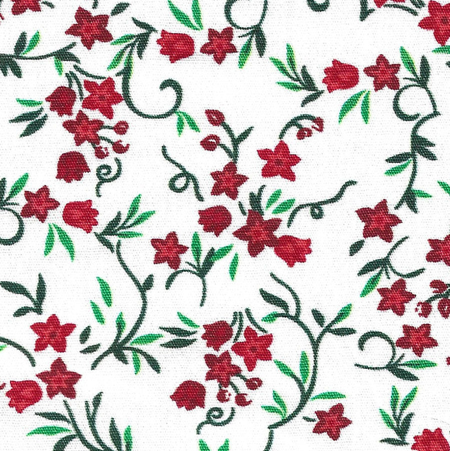 White cotton fabric with red floral and dark green vine print holiday pattern