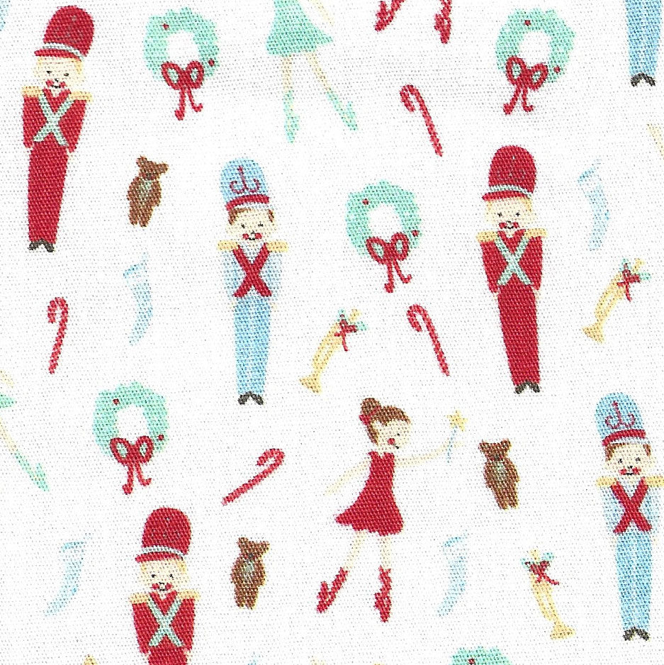 White cotton fabric with red toy soldiers, dolls, wreaths, candy canes, and teddy bears