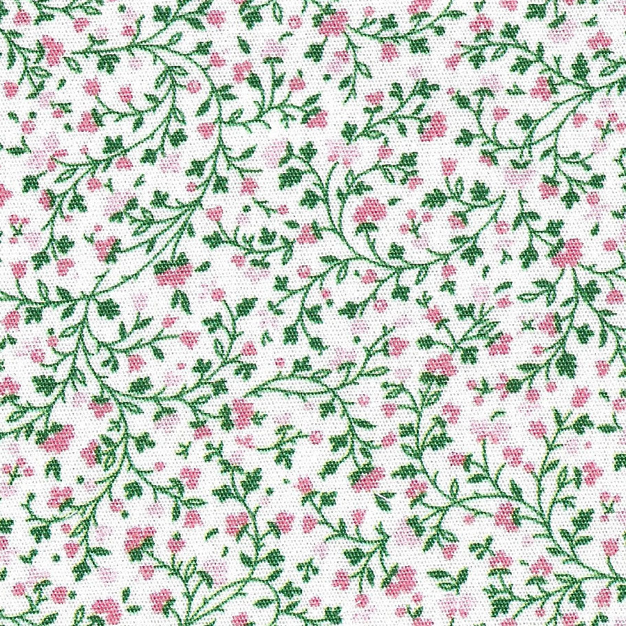 White cotton fabric with pink floral buds and green trailing vines allover print
