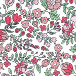 White cotton fabric with pink and red floral print and green leaves