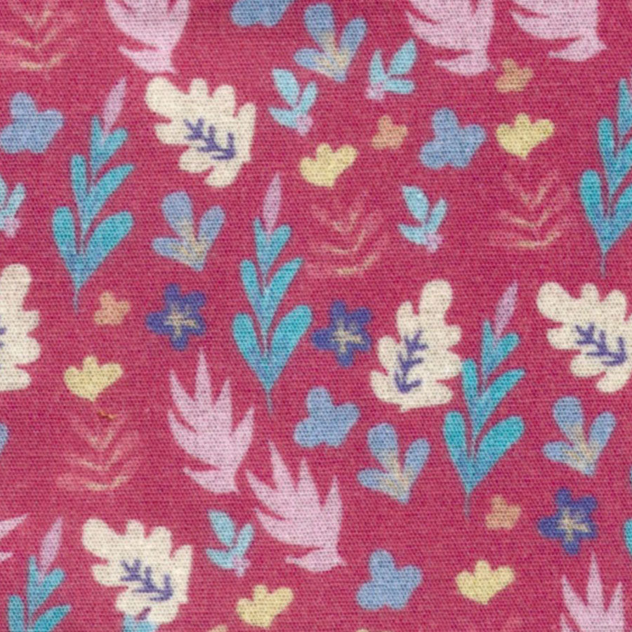 Raspberry red fabric with scattered multicolor hearts, leaves, and small floral motifs
