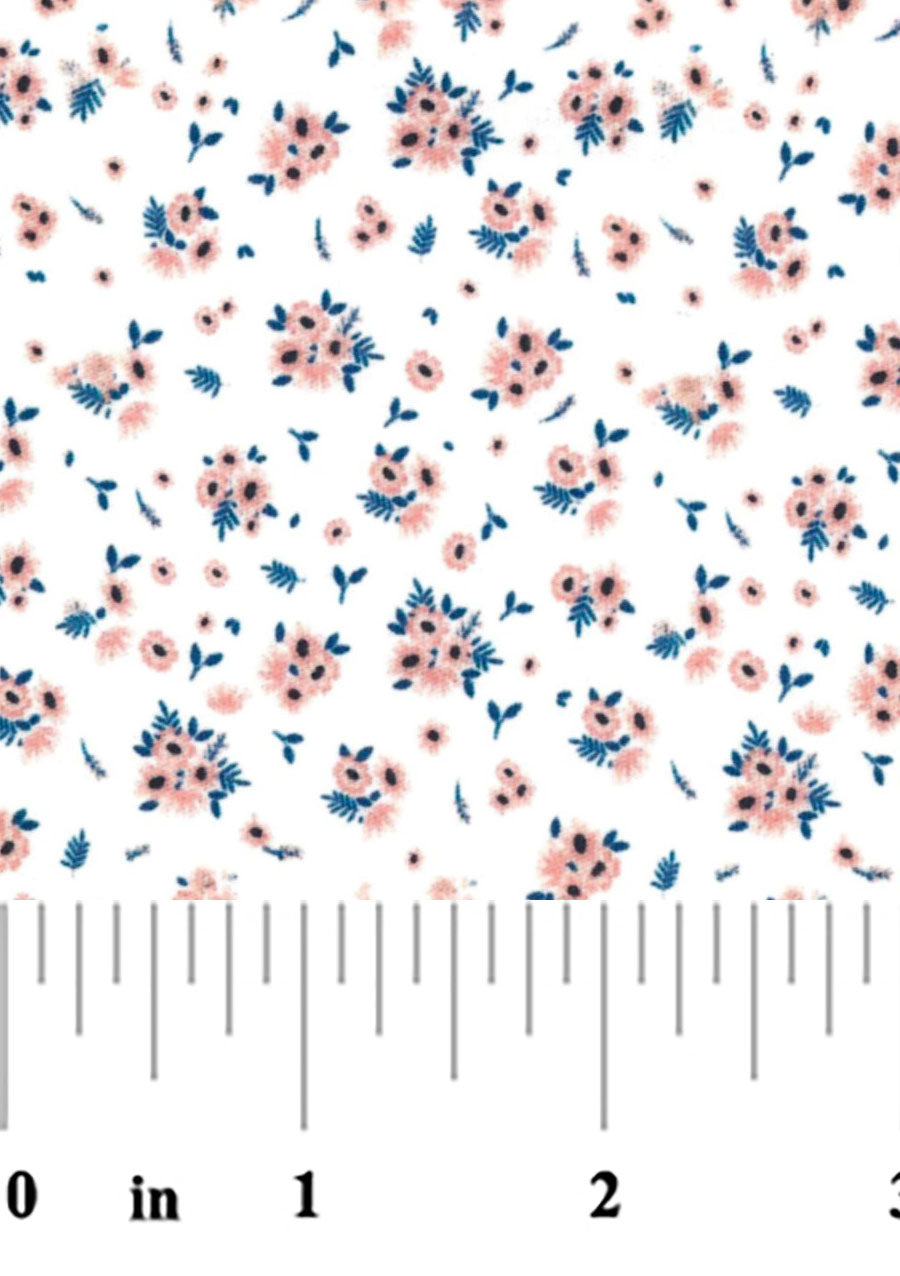 White cotton fabric with scattered pink floral bouquets and navy blue leaves pattern