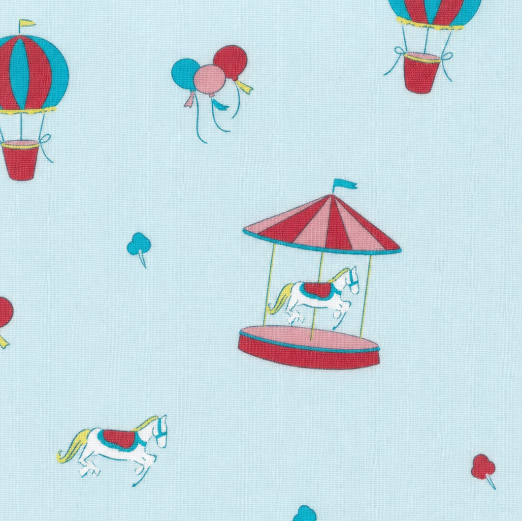 Light blue fabric with carousel horses, hot air balloons, and colorful balloons print