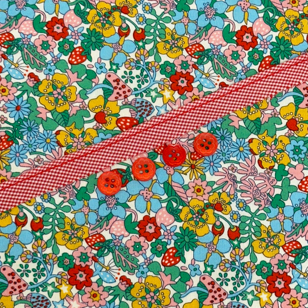 Colorful floral fabric kit with red gingham ribbon and four red flower buttons