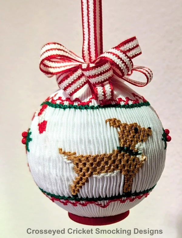 White smocked Christmas ornament with embroidered dachshund, red green trim, striped ribbon bow