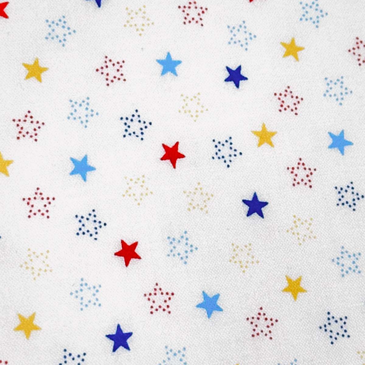 White cotton fabric with scattered multicolor red, blue, yellow solid and dotted stars