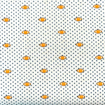 White fabric with navy polka dots and small orange football repeat pattern