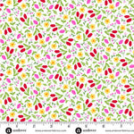 White cotton fabric with scattered red, yellow, and pink floral ditsy print and green leaves