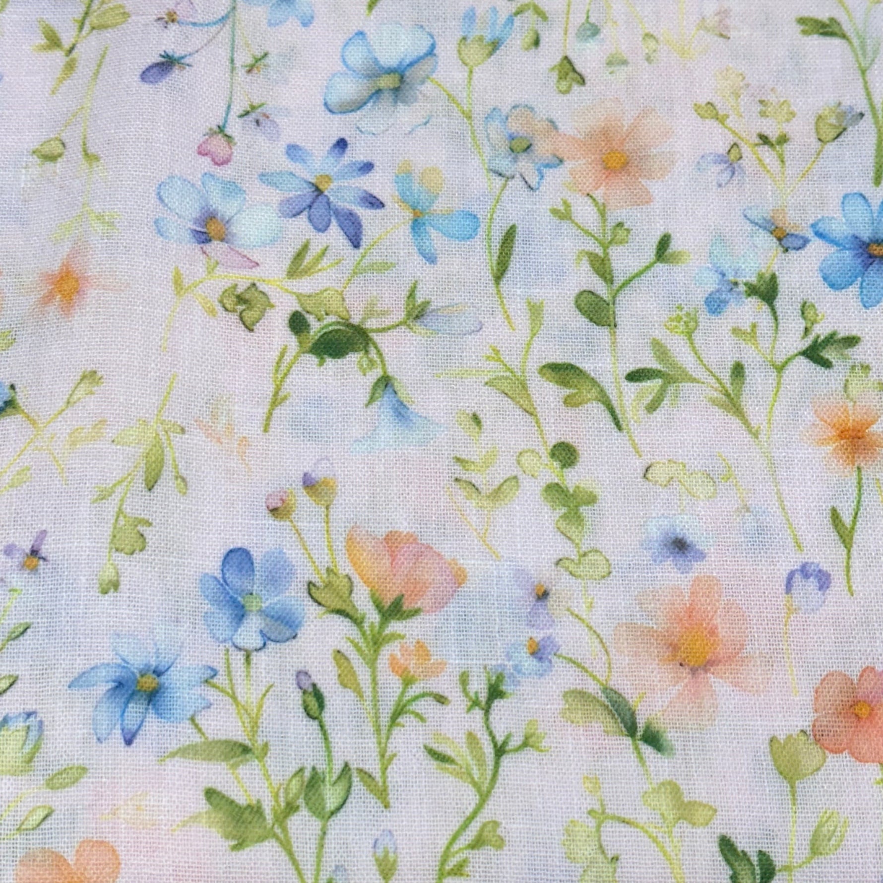 Woven poly fabric with pastel watercolor wildflowers in blue, peach, and green on white