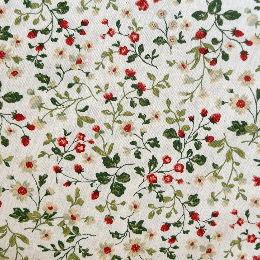 Cream fabric with red strawberries, tiny roses, and green vines floral print