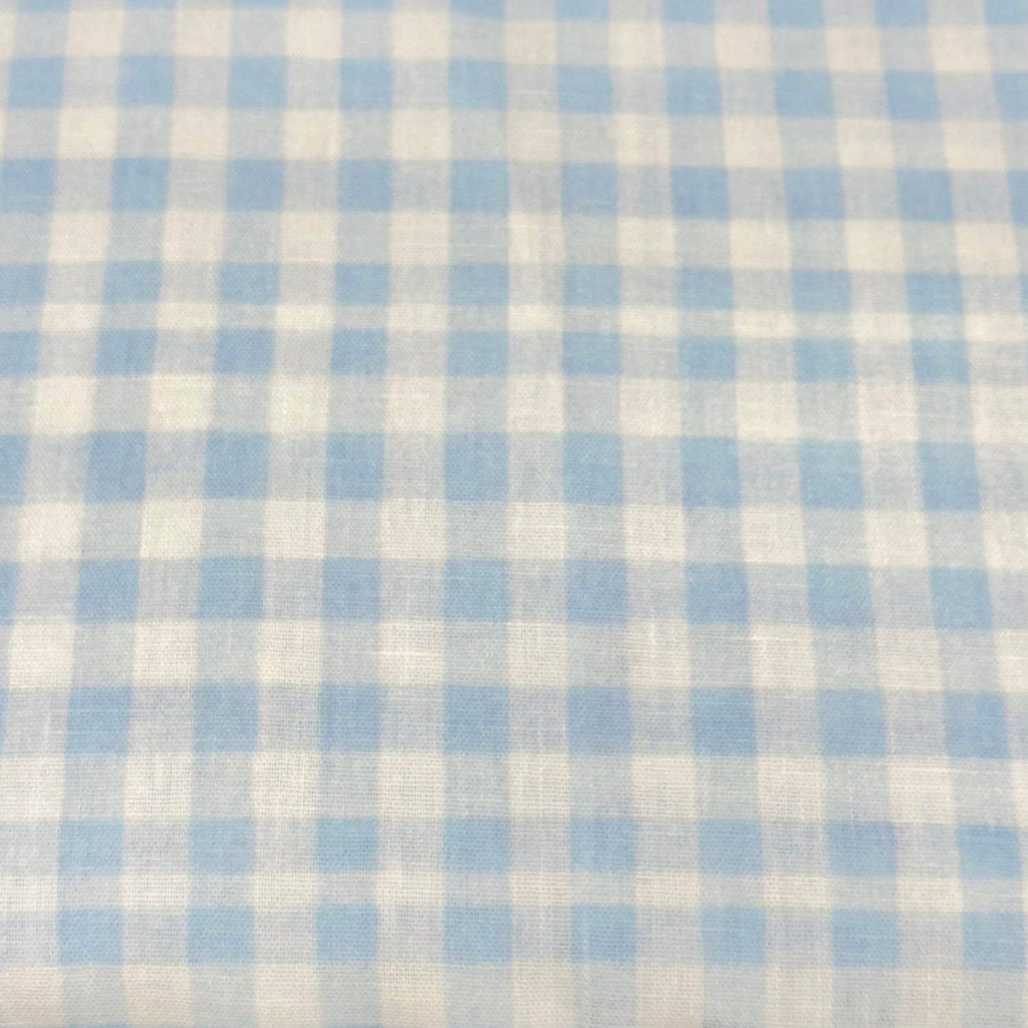 Light blue and white gingham check woven poly fabric, small uniform squares
