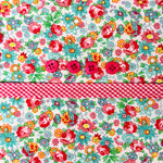 Floral cotton fabric with pink buttons and red gingham ribbon trim detail