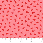 Pink cotton fabric with scattered red hearts pattern, shown with ruler for scale.