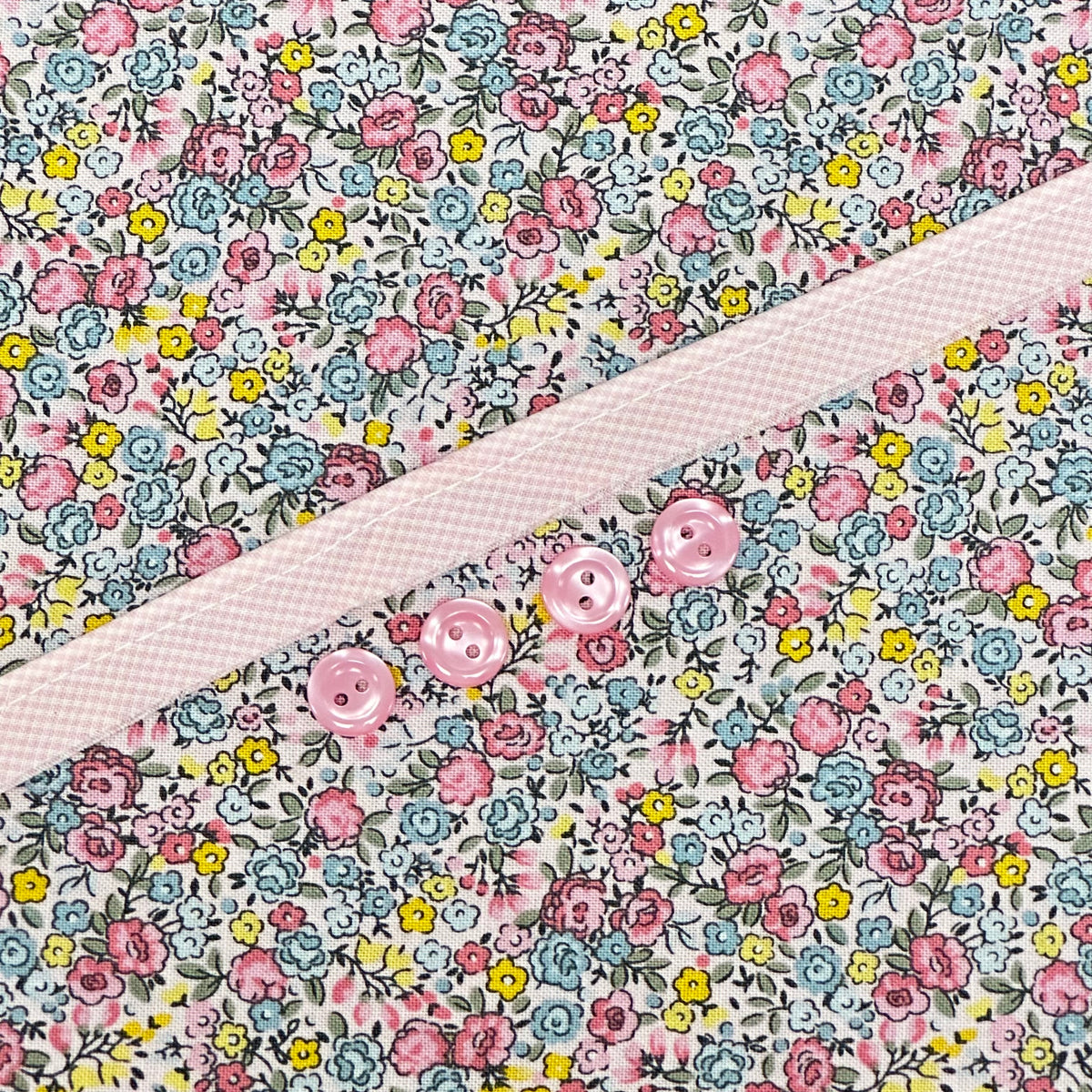 Floral cotton fabric with pink ditsy flowers and pink buttons on placket