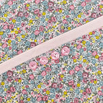 Floral cotton fabric with pink ditsy flowers and pink buttons on placket