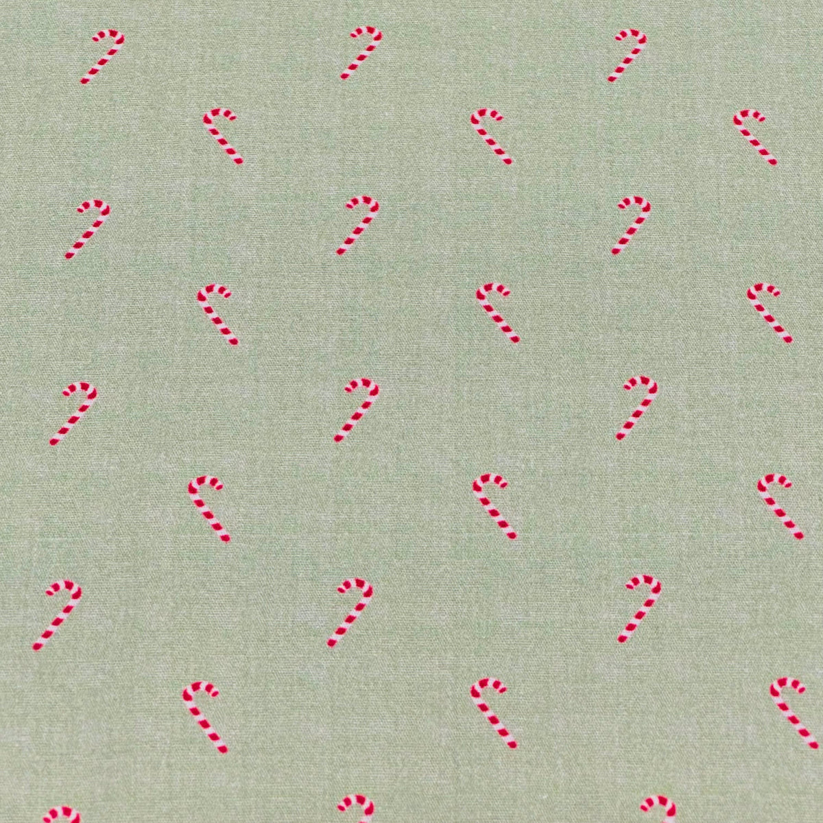 Sage green fabric with scattered red and white candy cane print pattern