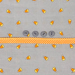 Gray candy corn print fabric with gray buttons and orange gingham ribbon trim