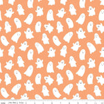 Orange cotton fabric with scattered white smiling ghost figures, Halloween pattern