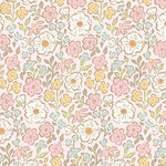 Little Posies pink main fabric featuring pastel floral pattern with white, pink, yellow, and blue flowers
