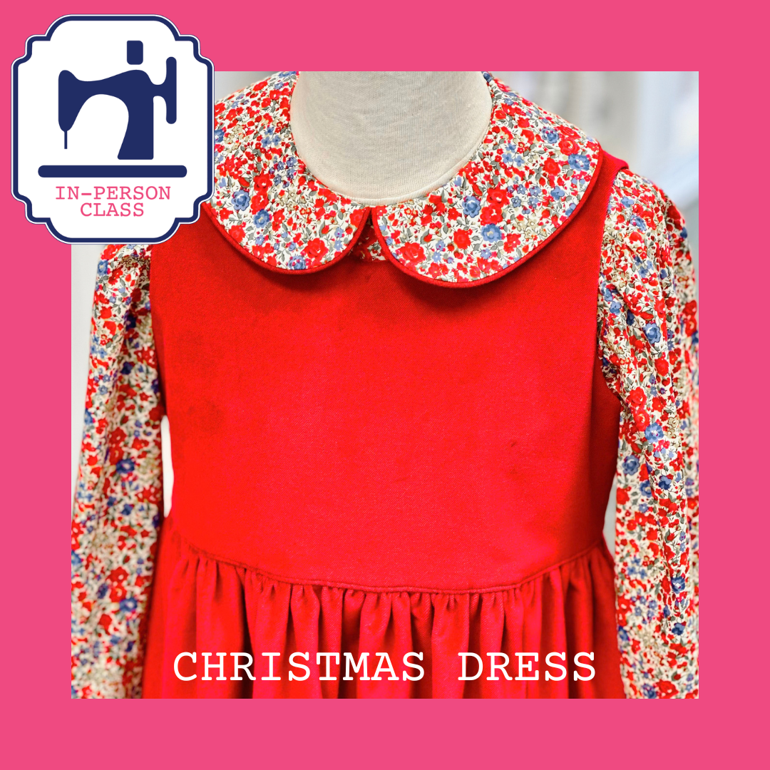 Red children's pinafore dress with floral blouse and Peter Pan collar on dress form