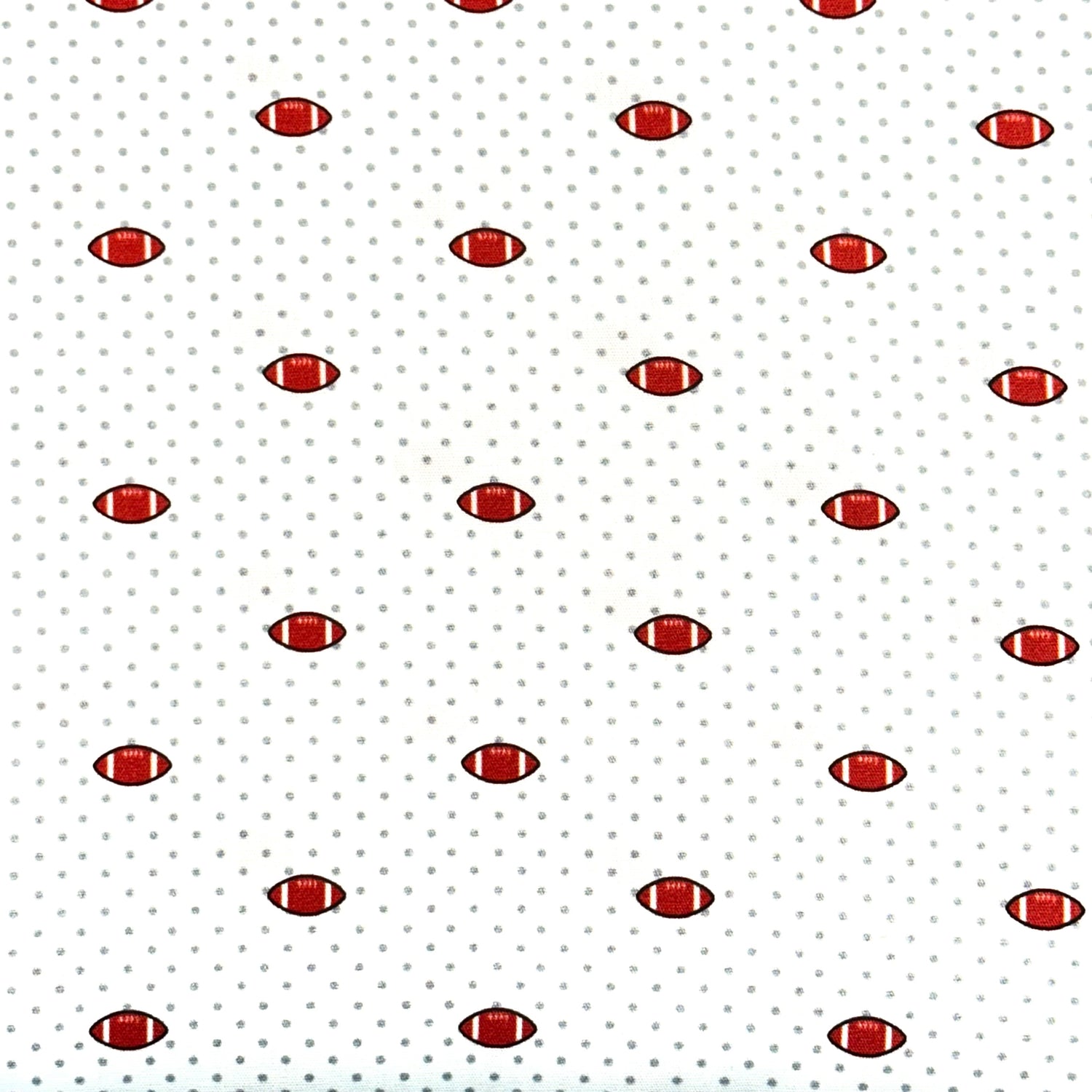 White fabric with small red footballs and gray polka dots repeating pattern