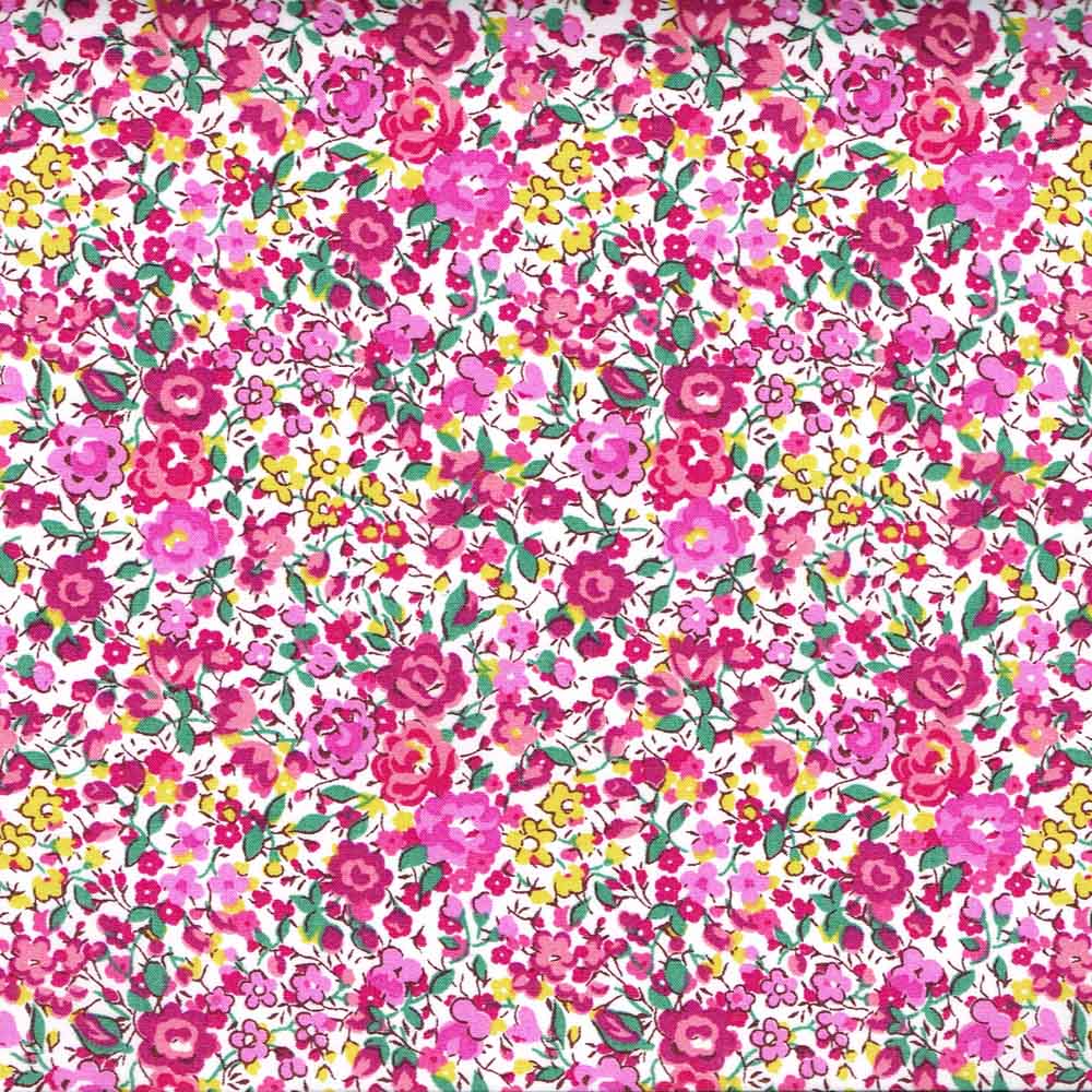 Liberty of London Emma and Georgina fabric with dense pink, magenta, and yellow floral print on white