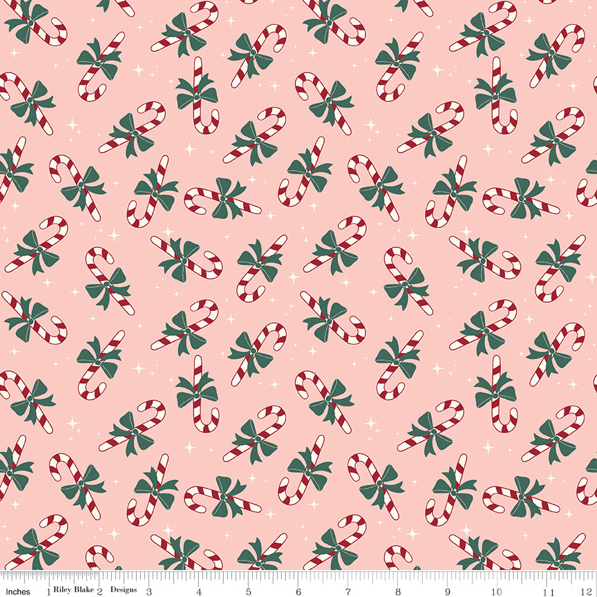 Pink flannel fabric with red and white candy canes and green bows pattern