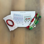 Chelsie smocking kit with red and green DMC floss, dotted fabric, and pattern card