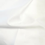 Soft white Swiss Batiste Nelona fabric with gentle folds showing smooth texture