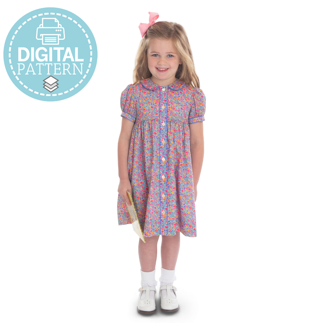 Girl wearing floral button-front dress with Peter Pan collar and puff sleeves