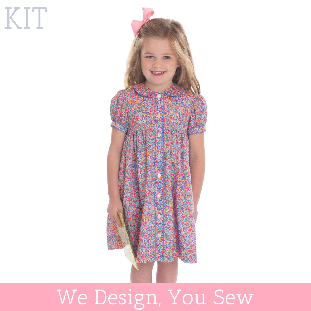 Girl wearing pink floral button-front dress with peter pan collar and puff sleeves