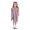 Girl wearing floral button-front dress with peter pan collar, puff sleeves, and pink hair bow
