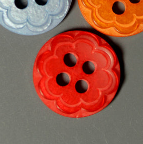 Scalloped flower plastic buttons in red, blue, and orange with four holes