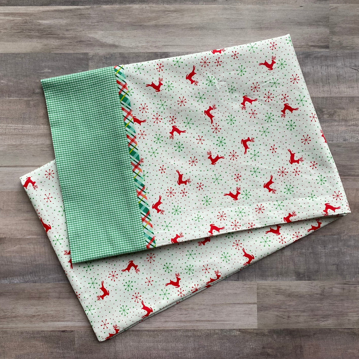 Christmas pillowcase kit with red reindeer snowflake print and green gingham cuff fabric