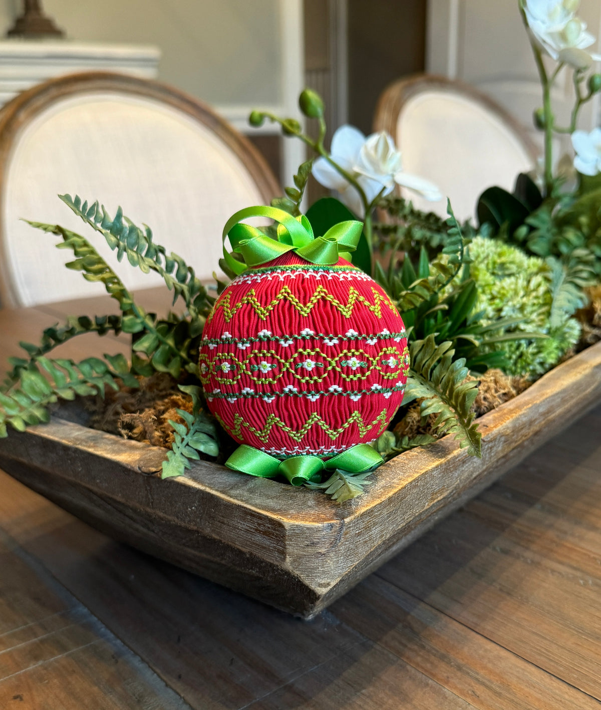Red smocked Christmas ornament with green zigzag embroidery and satin ribbon bow