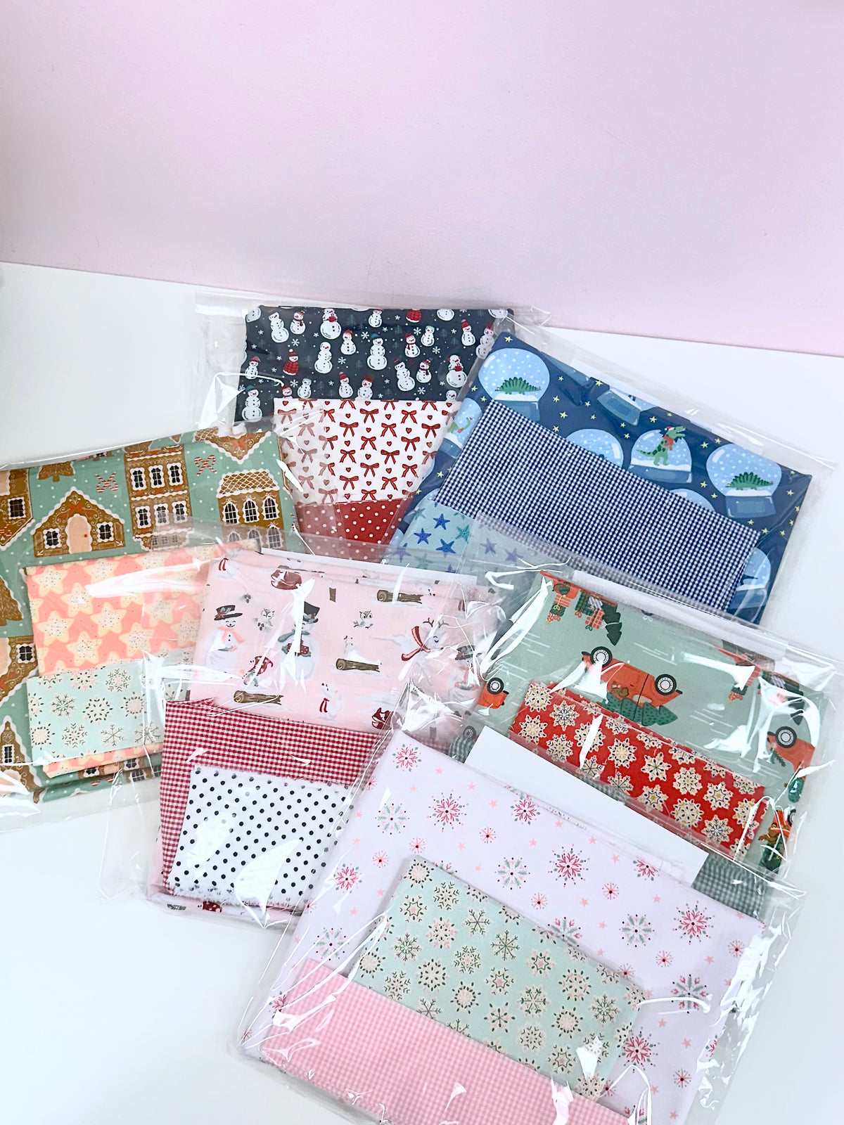 Christmas pillowcase fabric kits in festive prints: snowmen, snowflakes, gingerbread, plaid, and holiday scenes.